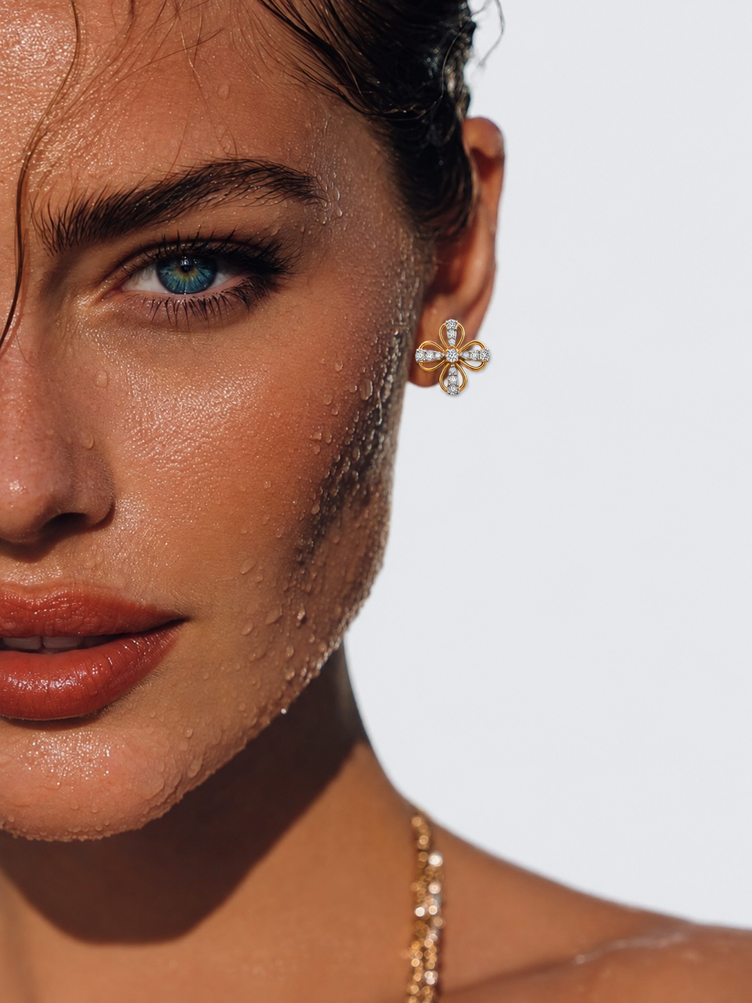 Model wearing a 14K gold floral cluster diamond stud earring by Oré